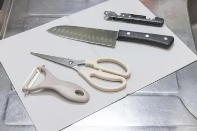 a pair of scissors and a knife on a piece of paper at Sanyouso in Tokyo