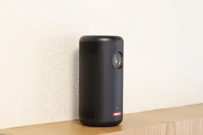 a black speaker sitting on a wooden shelf at Shibuya Shinjuku area Designer apartment in Tokyo