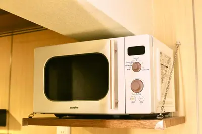 a microwave sitting on a shelf in a kitchen at Shibuya Shinjuku area Designer apartment in Tokyo