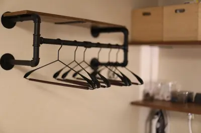 a black rack hanging on a wall in a kitchen at Shibuya Shinjuku area Designer apartment in Tokyo