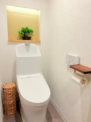 a bathroom with a toilet with a mirror and a plant at Shibuya Shinjuku area Designer apartment in Tokyo