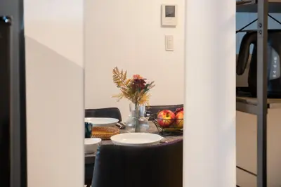 a dining room table with a bowl of fruit on it at \u30db\u30c6\u30eb\u5bcc\u58eb\u898b\u30de\u30f3\u30b7\u30e7\u30f3301 in Tokyo