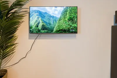 a flat screen tv hanging on a wall at \u30db\u30c6\u30eb\u5bcc\u58eb\u898b\u30de\u30f3\u30b7\u30e7\u30f3301 in Tokyo