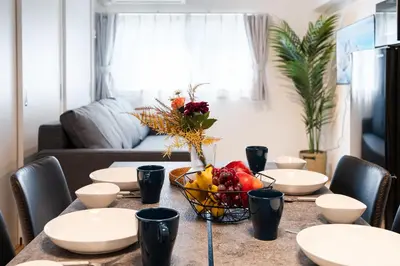 a dining room table with a bowl of fruit on it at \u30db\u30c6\u30eb\u5bcc\u58eb\u898b\u30de\u30f3\u30b7\u30e7\u30f3301 in Tokyo