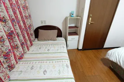 a small bedroom with a bed and a closet at Azabu House in Tokyo