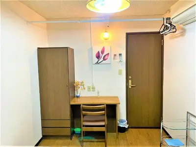 a room with a table with a chair and a door at Azabu House in Tokyo