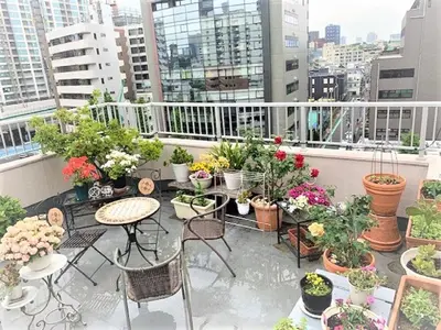 a balcony with tables and chairs and potted plants at Azabu House in Tokyo