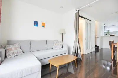 a living room with a couch and a table at Private Villa with Garage 10min to Ikebukuro Direct to Shinjuku, Shibuya & Airports in Tokyo