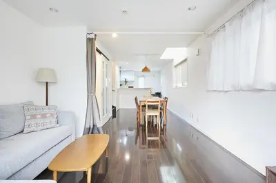 a living room with a couch and a table and chairs at Private Villa with Garage 10min to Ikebukuro Direct to Shinjuku, Shibuya & Airports in Tokyo