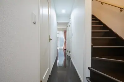 a hallway with a staircase in a house at Private Villa with Garage 10min to Ikebukuro Direct to Shinjuku, Shibuya & Airports in Tokyo