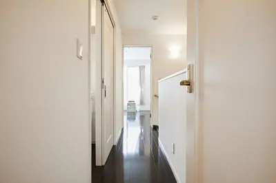 a hallway with a white door leading to a room at Private Villa with Garage 10min to Ikebukuro Direct to Shinjuku, Shibuya & Airports in Tokyo