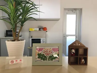 a plant in a vase and a box on a table at Private Villa with Garage 10min to Ikebukuro Direct to Shinjuku, Shibuya & Airports in Tokyo