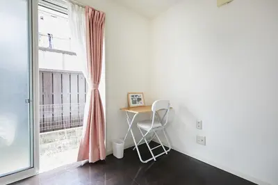 a table and a chair in a room with a window at Private Villa with Garage 10min to Ikebukuro Direct to Shinjuku, Shibuya & Airports in Tokyo