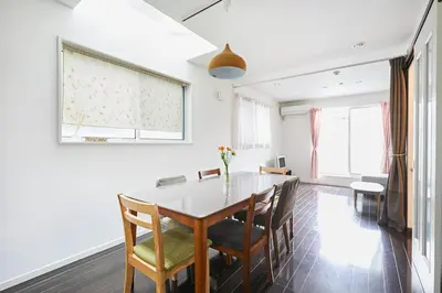 a dining room with a white table and chairs at Private Villa with Garage 10min to Ikebukuro Direct to Shinjuku, Shibuya & Airports in Tokyo