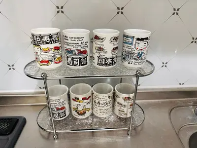 a group of coffee cups on a rack in a kitchen at \u6e0b\u8c37\u5bbf in Tokyo