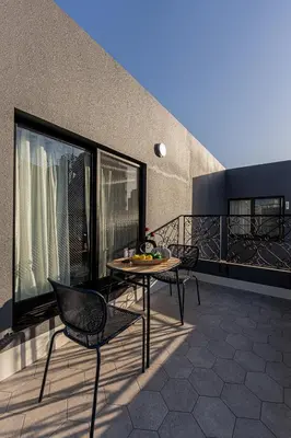 a patio with a table and chairs on a balcony at Mi-HOTEL Kitashinjuku in Tokyo