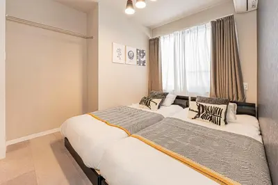 a bedroom with a large bed and a window at Mi-HOTEL Kitashinjuku in Tokyo