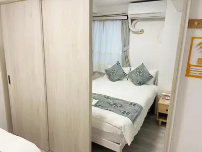 a small bedroom with a bed and a window at \u6696\u71c8 DANTO inn 5F in Tokyo