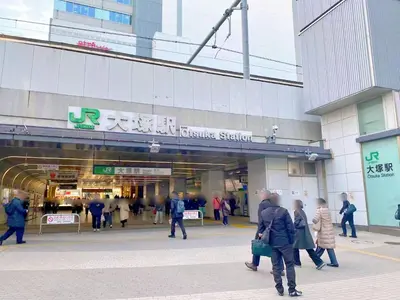 a group of people walking in front of a building at \u6696\u71c8 DANTO inn 5F in Tokyo