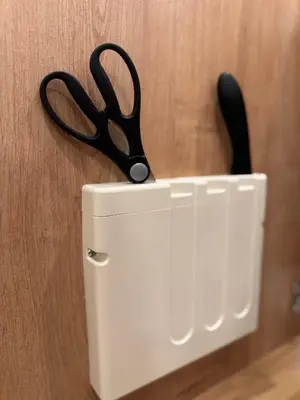 a pair of scissors sticking out of a white holder at ISSHUKU Noma \u5317\u65b0\u5bbfI -301 Triple Room in Tokyo