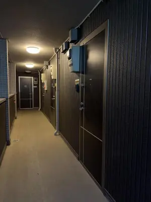 a hallway of a locker room with a long aisle at ISSHUKU NOMA\u6c60\u888bII 101 - Spacious Room for 5 Guests in Tokyo