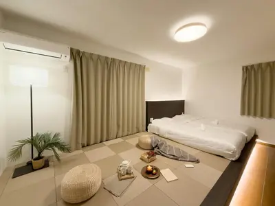 a hotel room with a bed and a table at ISSHUKU NOMA\u6c60\u888bII 101 - Spacious Room for 5 Guests in Tokyo