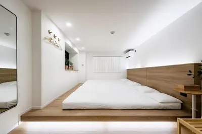 a bedroom with a bed in the middle of a room at ISSHUKU Noma \u5317\u65b0\u5bbfI -302 Quad Room in Tokyo