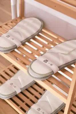 a pair of sandals sitting on a shelf at ISSHUKU Noma \u5317\u65b0\u5bbfI -302 Quad Room in Tokyo