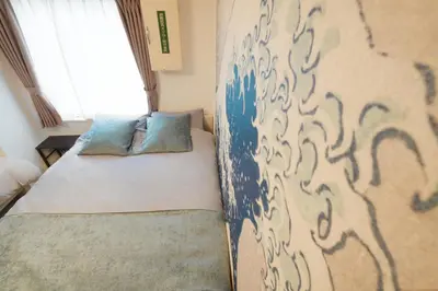 a small bedroom with a bed and a window at \u99c5\u5f92\u6b695\u5206 Sugamo Yasu Hotel in Tokyo