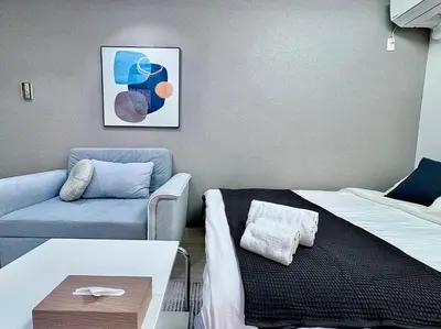 a living room with a bed and a couch at Kabukicho Designer's Apt VIII in Tokyo