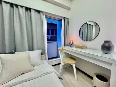 a bedroom with a bed and a desk with a mirror at Kabukicho Designer's Apt VIII in Tokyo