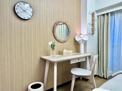 a bathroom with a desk and a clock on the wall at Kabukicho Designer's Apt X in Tokyo