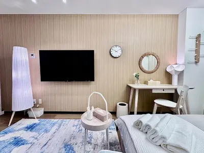 a bedroom with a tv and a bed and a desk at Kabukicho Designer's Apt X in Tokyo