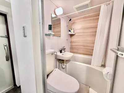 a small bathroom with a toilet and a sink at Kabukicho Designer's Apt X in Tokyo