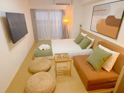 a small room with a bed and a couch at Shinjuku Kabukicho Apt XI in Tokyo