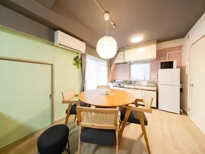 a kitchen with a table and chairs and a refrigerator at 4min Shibuya Sta,3min Shinsen Sta,Central Shibuya,family-friendly,Switch, movies, Wi-Fi in Tokyo