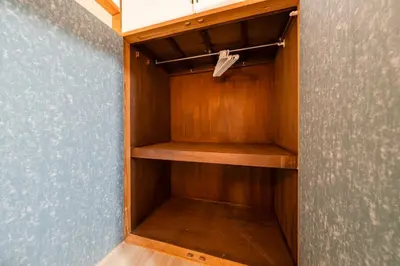 a closet with wooden shelves and a blue wall at 4min Shibuya Sta,3min Shinsen Sta,Central Shibuya,family-friendly,Switch, movies, Wi-Fi in Tokyo