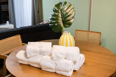 a table with towels on it with a vase on it at 4min Shibuya Sta,3min Shinsen Sta,Central Shibuya,family-friendly,Switch, movies, Wi-Fi in Tokyo
