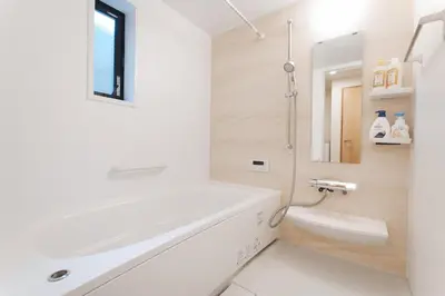 a bathroom with a white tub and a sink at House no7 in Tokyo
