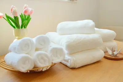 a pile of towels in a basket on a table at House no7 in Tokyo