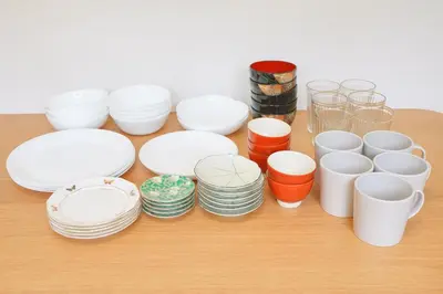 a group of white plates and cups on a table at House no7 in Tokyo