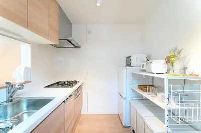 a kitchen with a sink and a refrigerator at House no7 in Tokyo