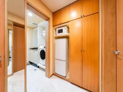 a kitchen with wooden cabinets and a washer and dryer at Roppongi sta 3min , Akasaka Sta, 3min,Family & Group Stay,WiFi, Switch,King bed in Tokyo