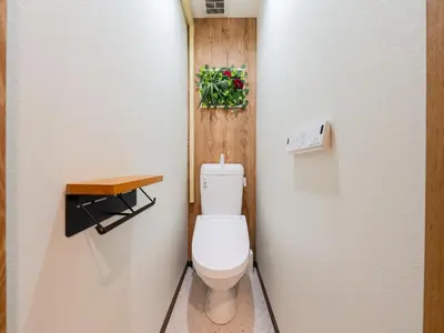 a bathroom with a toilet with a plant on the wall at Roppongi sta 3min , Akasaka Sta, 3min,Family & Group Stay,WiFi, Switch,King bed in Tokyo