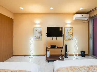 a bedroom with a tv on the wall at Roppongi sta 3min , Akasaka Sta, 3min,Family & Group Stay,WiFi, Switch,King bed in Tokyo