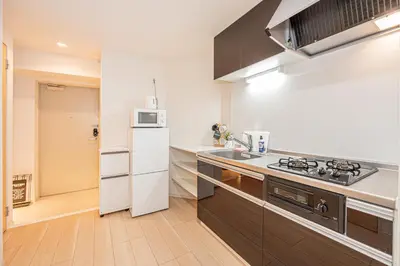 a kitchen with a white refrigerator and a microwave at Louis stage asakusa in Tokyo
