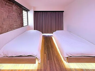 a bedroom with two beds and a window at Spacious Family Stay Shinagawa-Kokoro House in Tokyo
