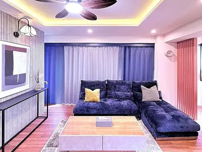 a living room with a blue couch and a tv at Spacious Family Stay Shinagawa-Kokoro House in Tokyo