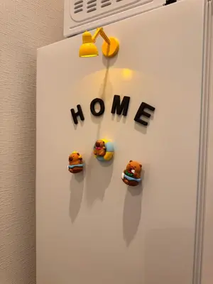a refrigerator with the words home and toy cars on it at Nexus Villa Morishita in Tokyo