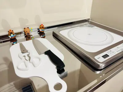 a pair of scissors and a knife in a drawer at Nexus Villa Morishita in Tokyo